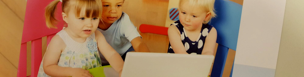 Drei Kinder sitzen vor einem Laptop